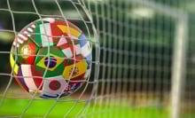 A soccer ball flying into a goal.