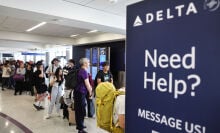"Need Help?" sign at Delta Airlines check-in counter at airport