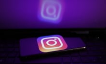 A glowing phone screen shows the Instagram logo.