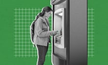 A woman has cash at an ATM machine.