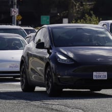 Tesla vehicles drive on the street on February 2, 2024 in San Bruno, California.