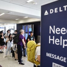 "Need Help?" sign at Delta Airlines check-in counter at airport