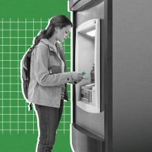 A woman has cash at an ATM machine.