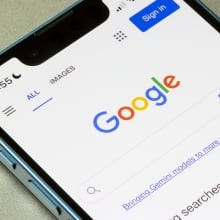 Homepage of Google.com, showing a Gemini link, is seen on an iPhone.