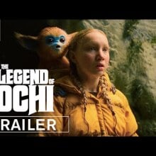 A girl with a small golden creature on her back.
