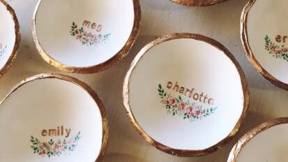 White dishes with names in gold