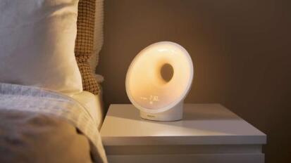 round lamp with hole in it on bedside table