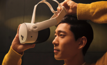a close-up of a man putting on a meta quest 3s headset