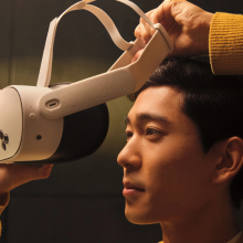 a close-up of a man putting on a meta quest 3s headset