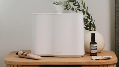 white vitruvi humidifier on nightstand next to aesop products