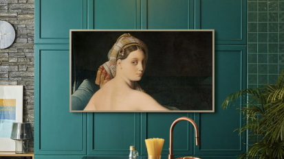 TV displaying art on blue wall
